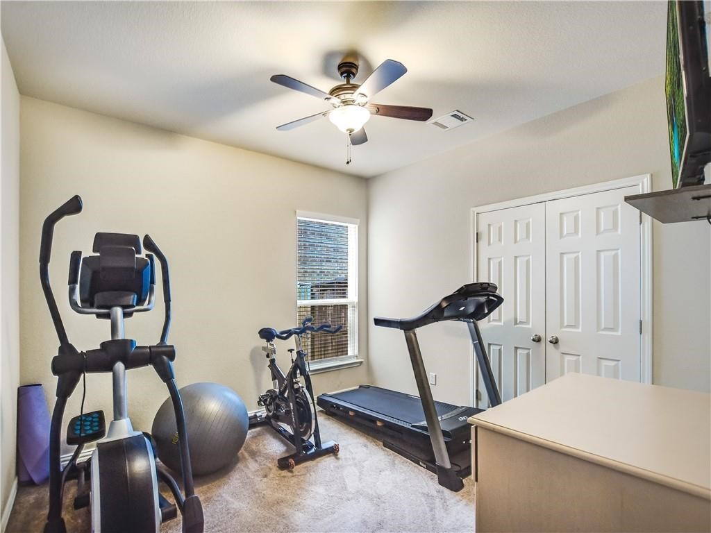 137 Nantucket Circle Austin, TX 78737 - Photo 16 of 34 a room with gym equipment and windows