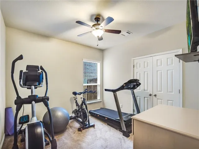 a room with gym equipment and windows