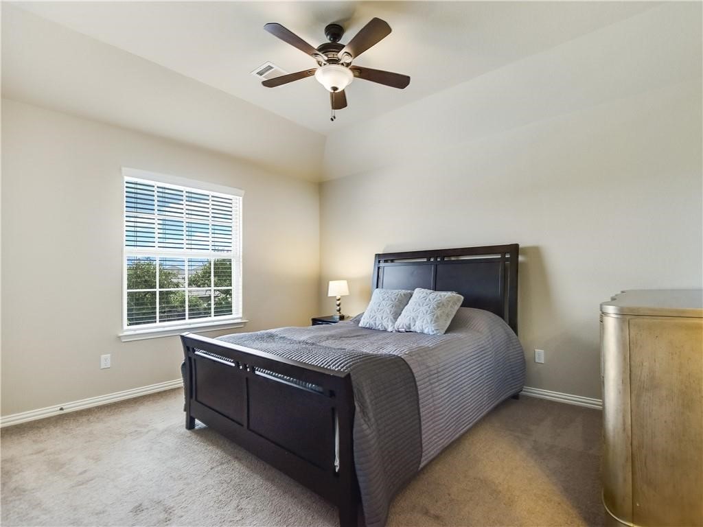 137 Nantucket Circle Austin, TX 78737 - Photo 23 of 34 a bedroom with a bed and window
