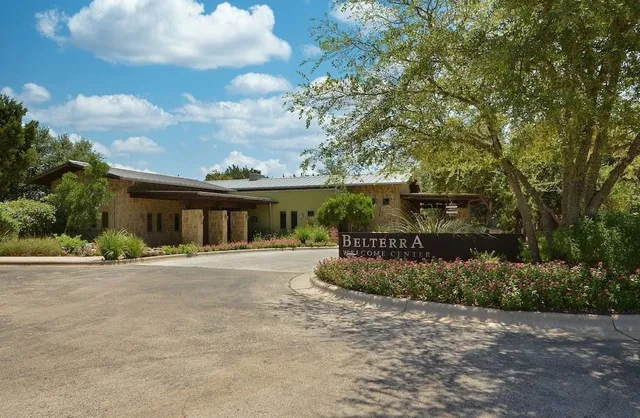 a front view of house with a garden