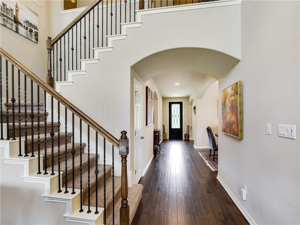 137 Nantucket Circle Austin, TX 78737 - Photo 4 of 34 a view of staircase with railing and a chandelier