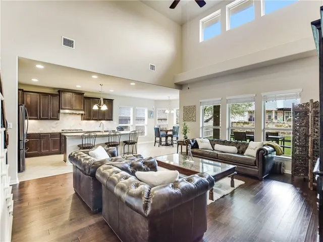 a living room with furniture and kitchen view
