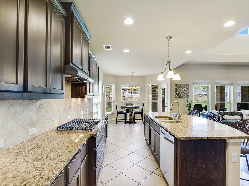 137 Nantucket Circle Austin, TX 78737 - Photo 8 of 34 a kitchen with stainless steel appliances granite countertop a sink a counter top space and living room view