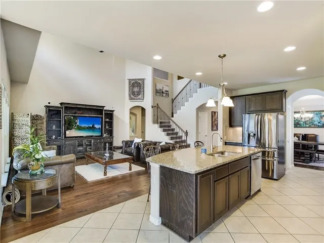 a living room with couches a fireplace and a flat screen tv