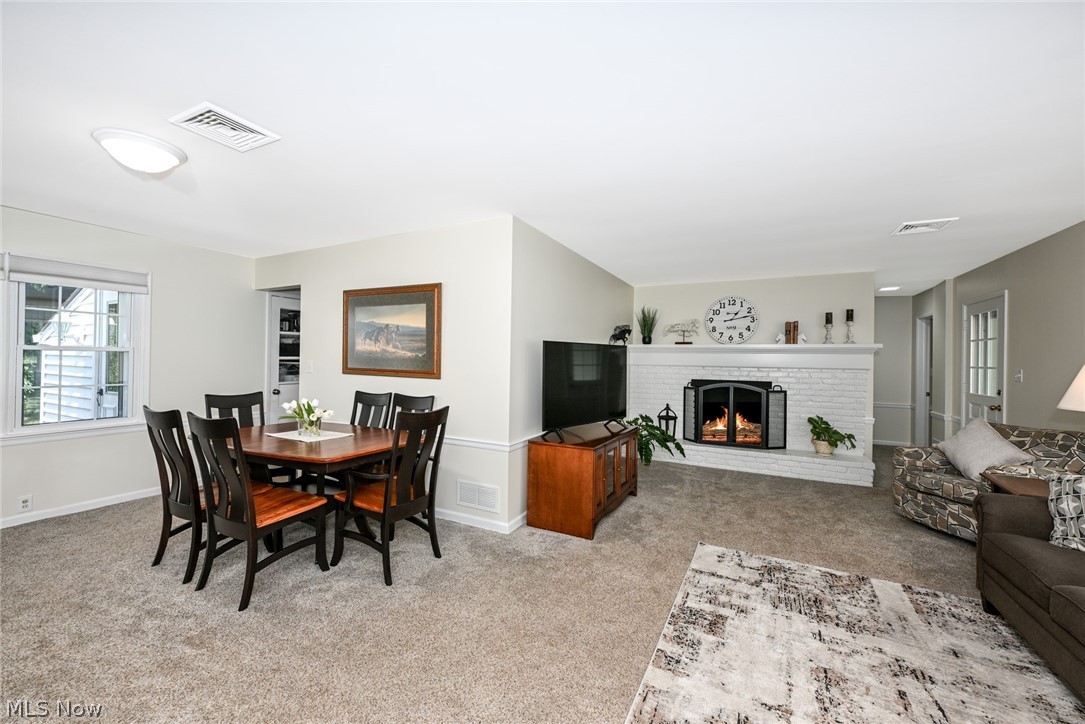 24481 Barrett Road Olmsted Falls, OH 44138 - Photo 20 of 49 Dining / living room area with carpet and gas fireplace