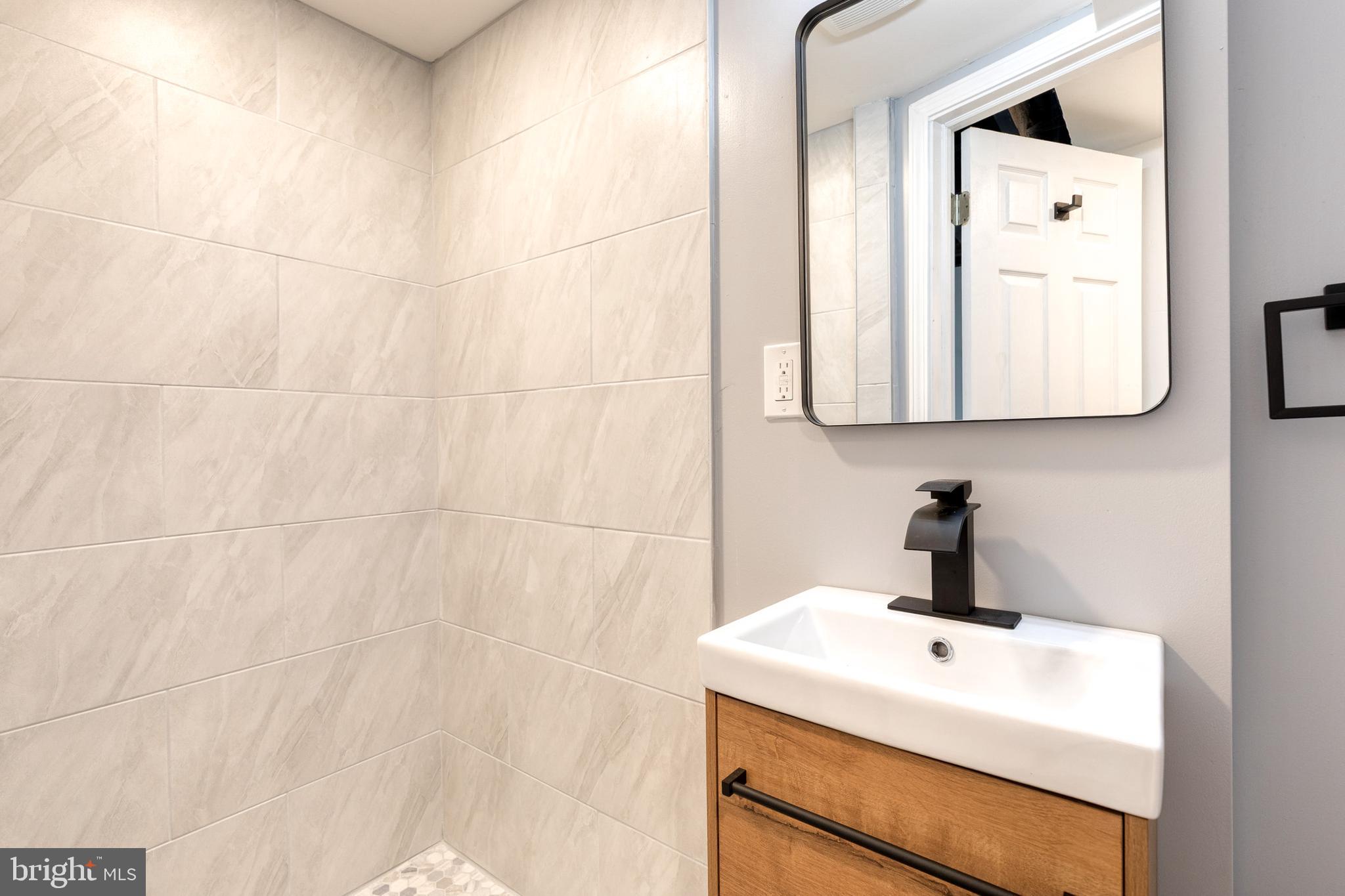 2708 Uhler Avenue Baltimore, MD 21215 - Photo 16 of 18 a bathroom with a sink and a mirror