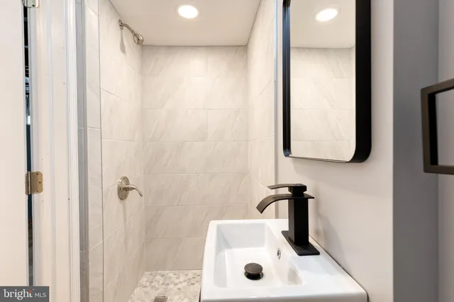a bathroom with a sink and mirror