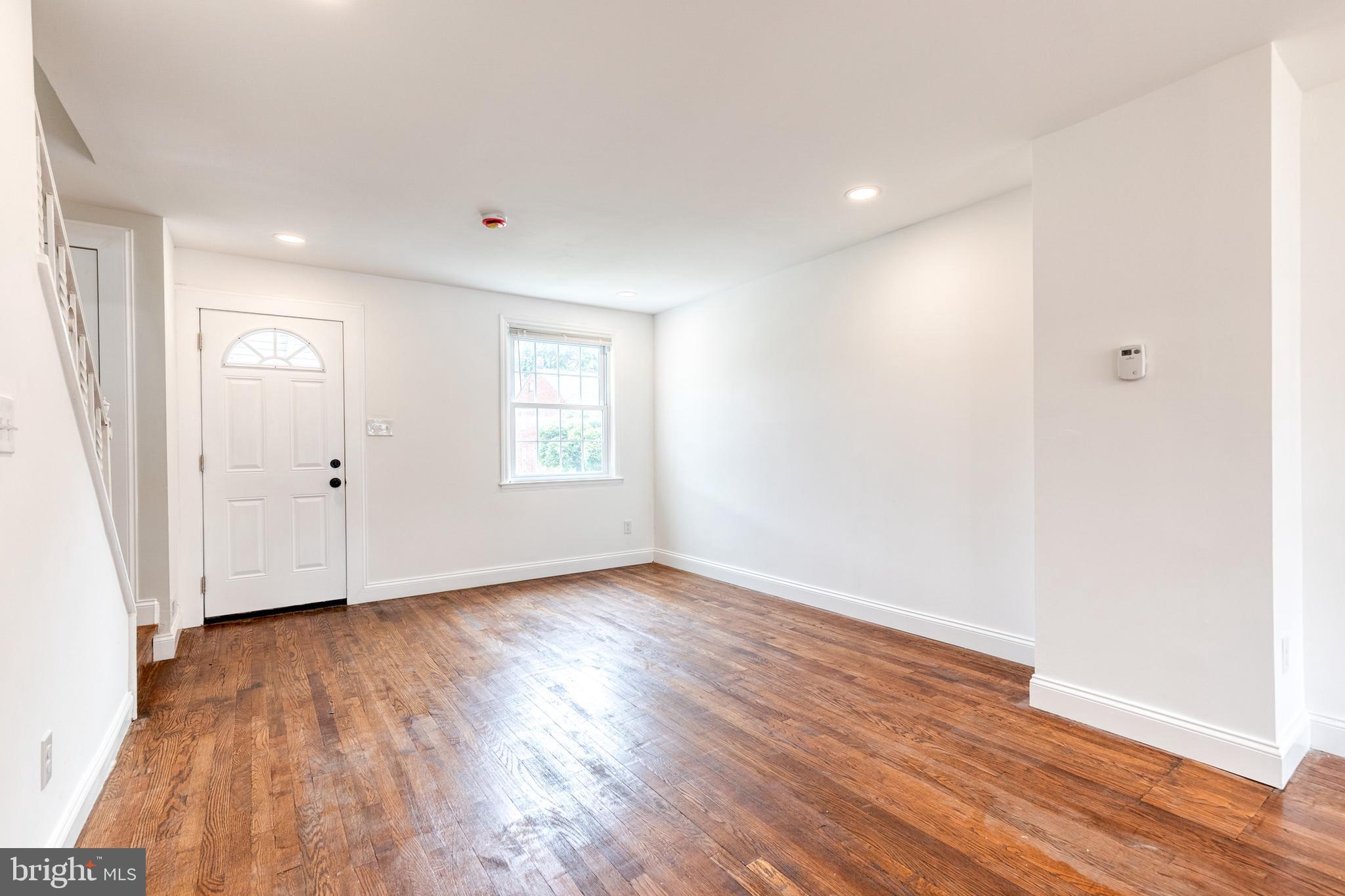 2708 Uhler Avenue Baltimore, MD 21215 - Photo 3 of 18 wooden floor in an empty room with a window