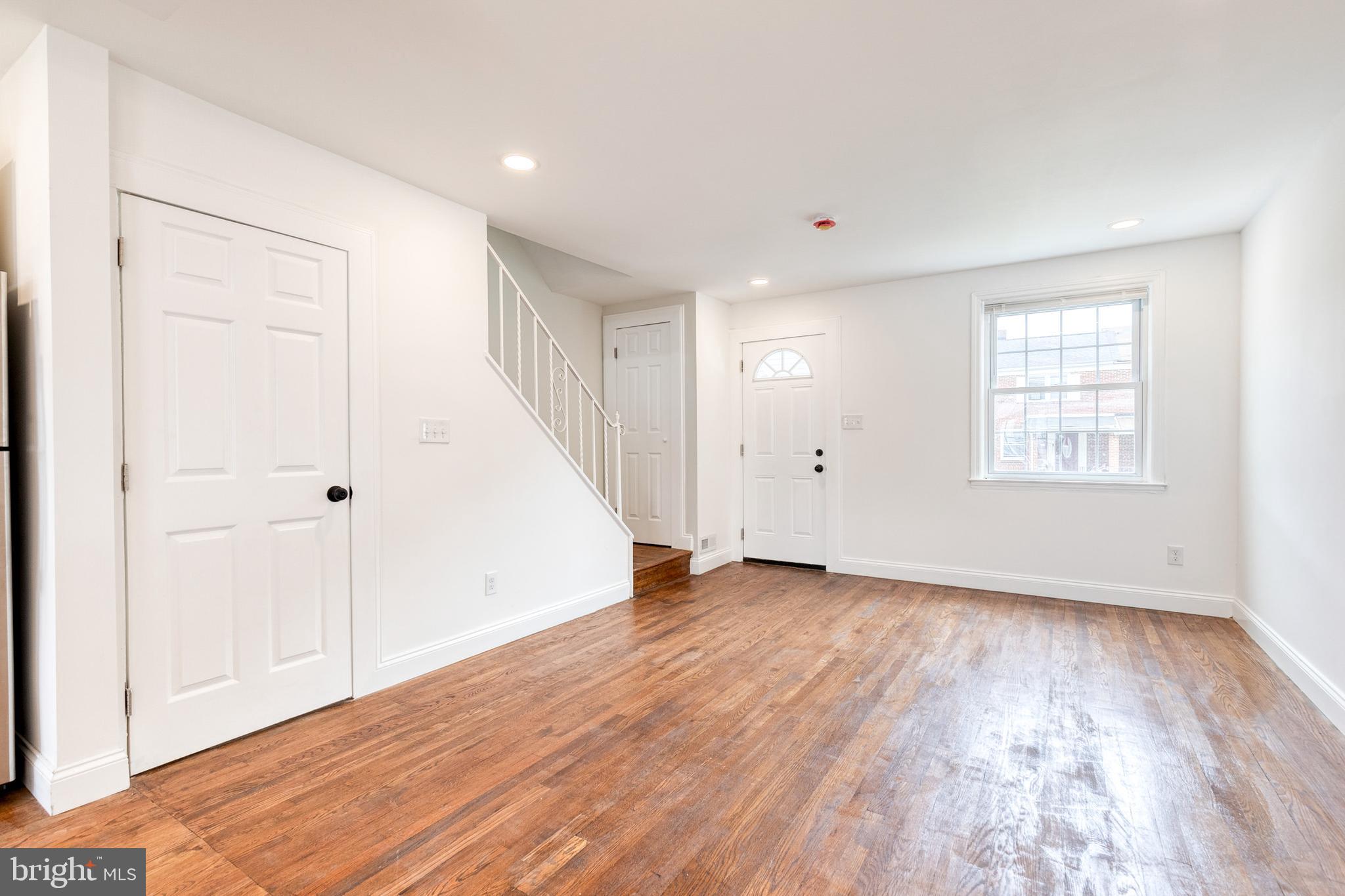 2708 Uhler Avenue Baltimore, MD 21215 - Photo 4 of 18 wooden floor in an empty room with a window