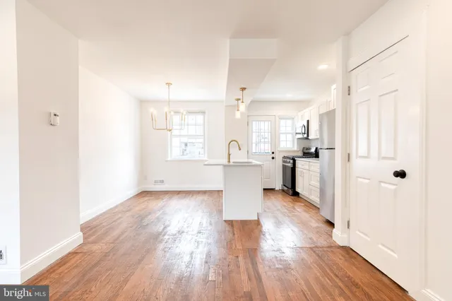a view of a kitchen with wooden floor and a kitchen
