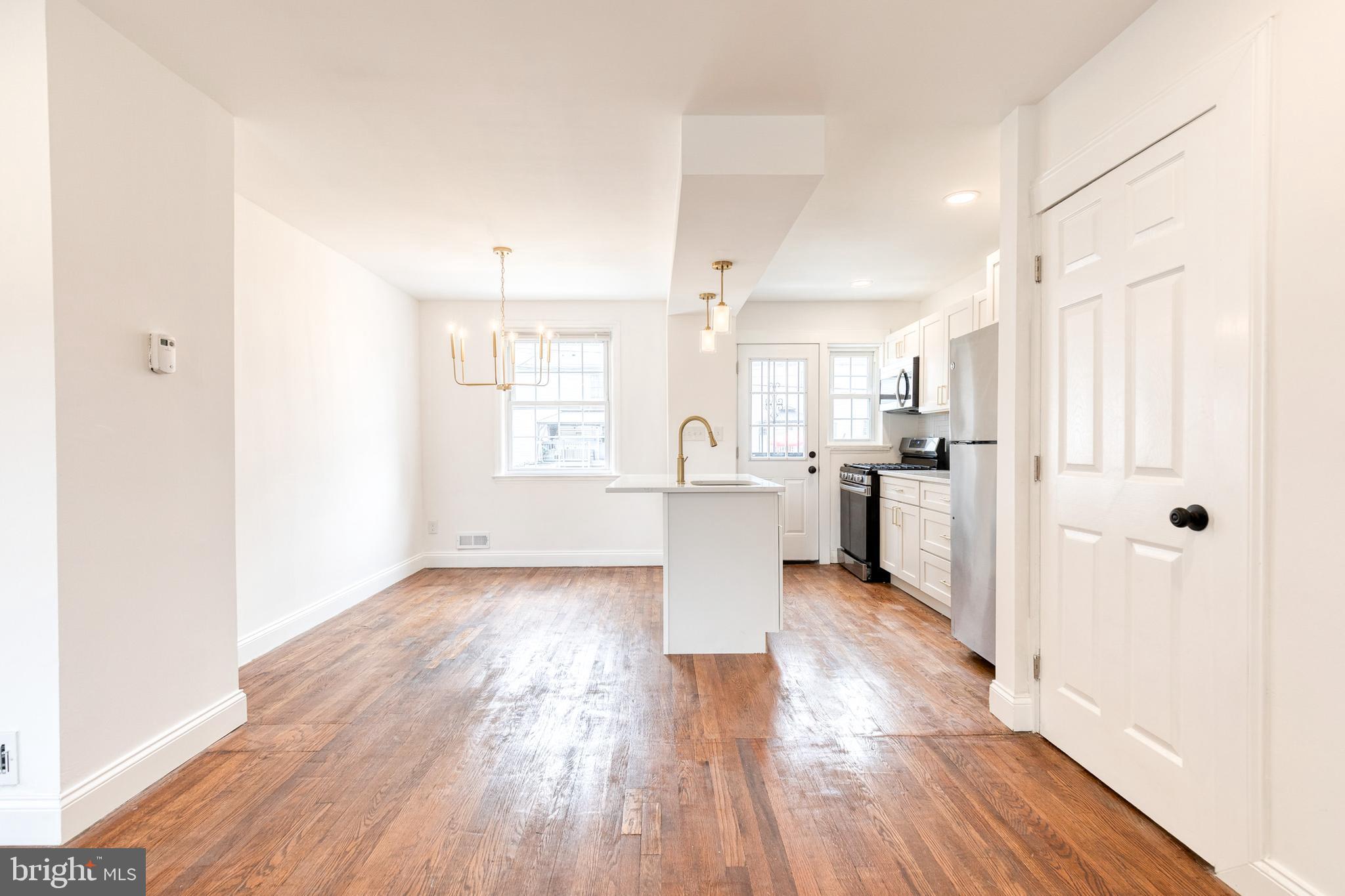 2708 Uhler Avenue Baltimore, MD 21215 - Photo 5 of 18 a view of a kitchen with wooden floor and a kitchen
