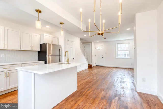 a view of a kitchen with a sink and microwave