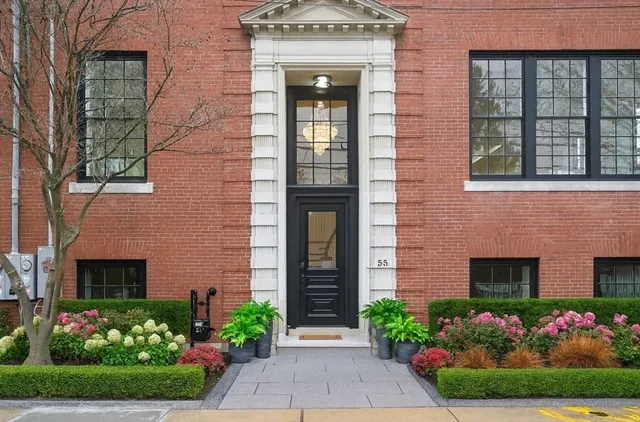 front view of a house with potted plants
