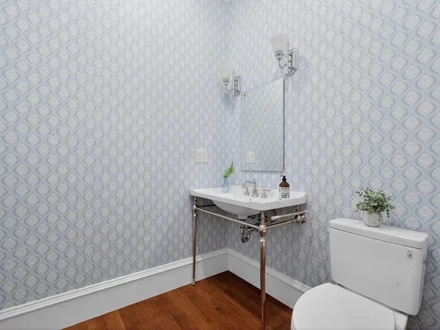 a bathroom with a sink a toilet and vanity