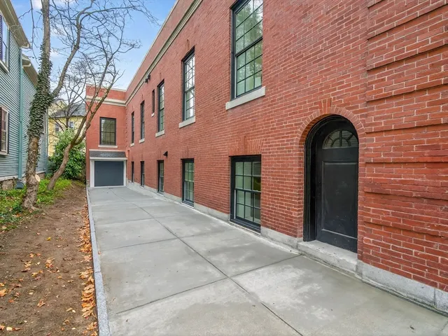 a view of a brick house with a large windows