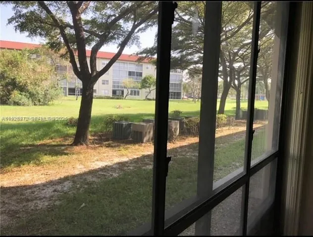 a view of a yard with a tree