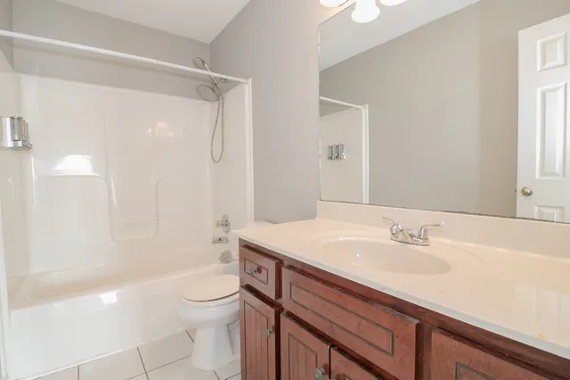 a front view of a house with a garden and plants