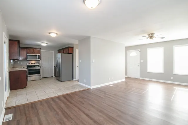 a view of a kitchen with a sink a refrigerator and window