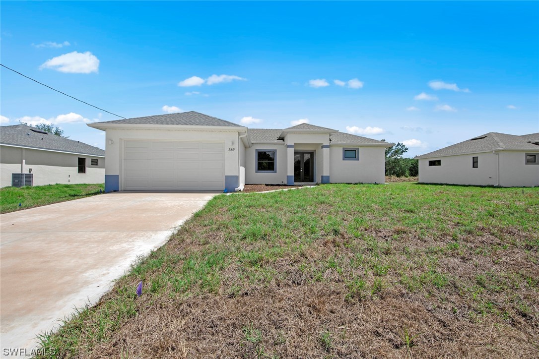 a front view of a house with a yard and garage