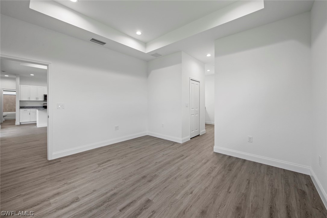367 Ranier Avenue Lehigh Acres, FL 33974 - Photo 12 of 24 a view of an empty room with wooden floor