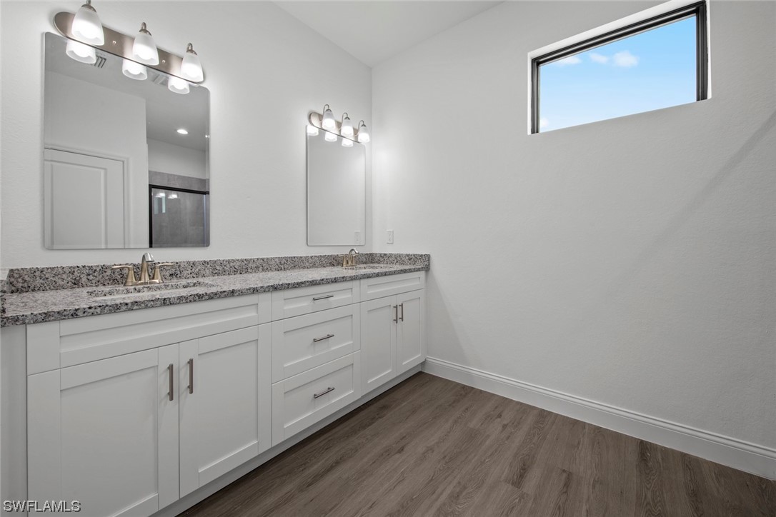 367 Ranier Avenue Lehigh Acres, FL 33974 - Photo 14 of 24 a bathroom with a granite countertop sink and a mirror