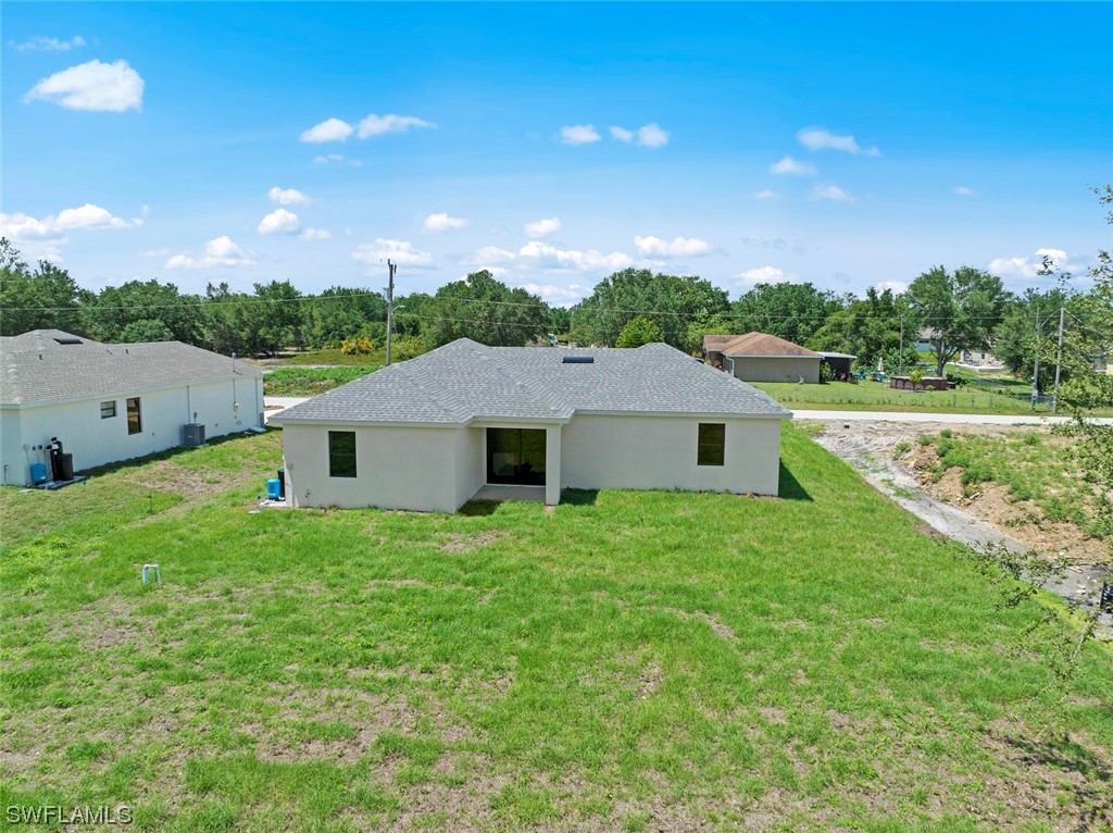 367 Ranier Avenue Lehigh Acres, FL 33974 - Photo 24 of 24 a house view with a garden space