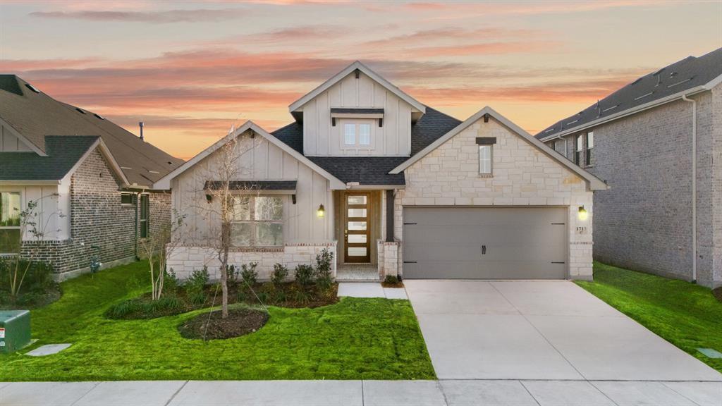 a view of a big house with a big yard and potted plants