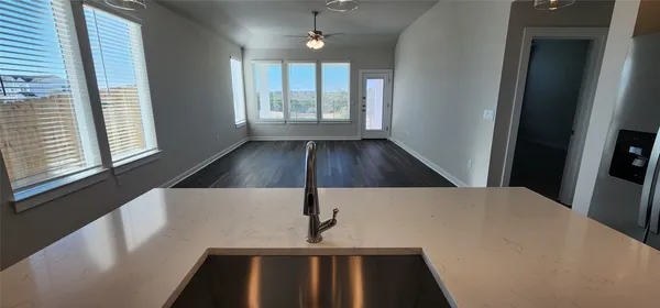 a view of wooden floor and windows in an empty room