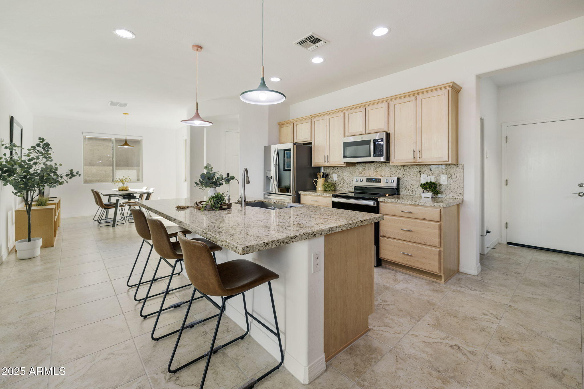 5823 South Del Rancho Mesa, AZ 85212 - Photo 11 of 67 a kitchen with stainless steel appliances kitchen island granite countertop a stove a sink and a refrigerator