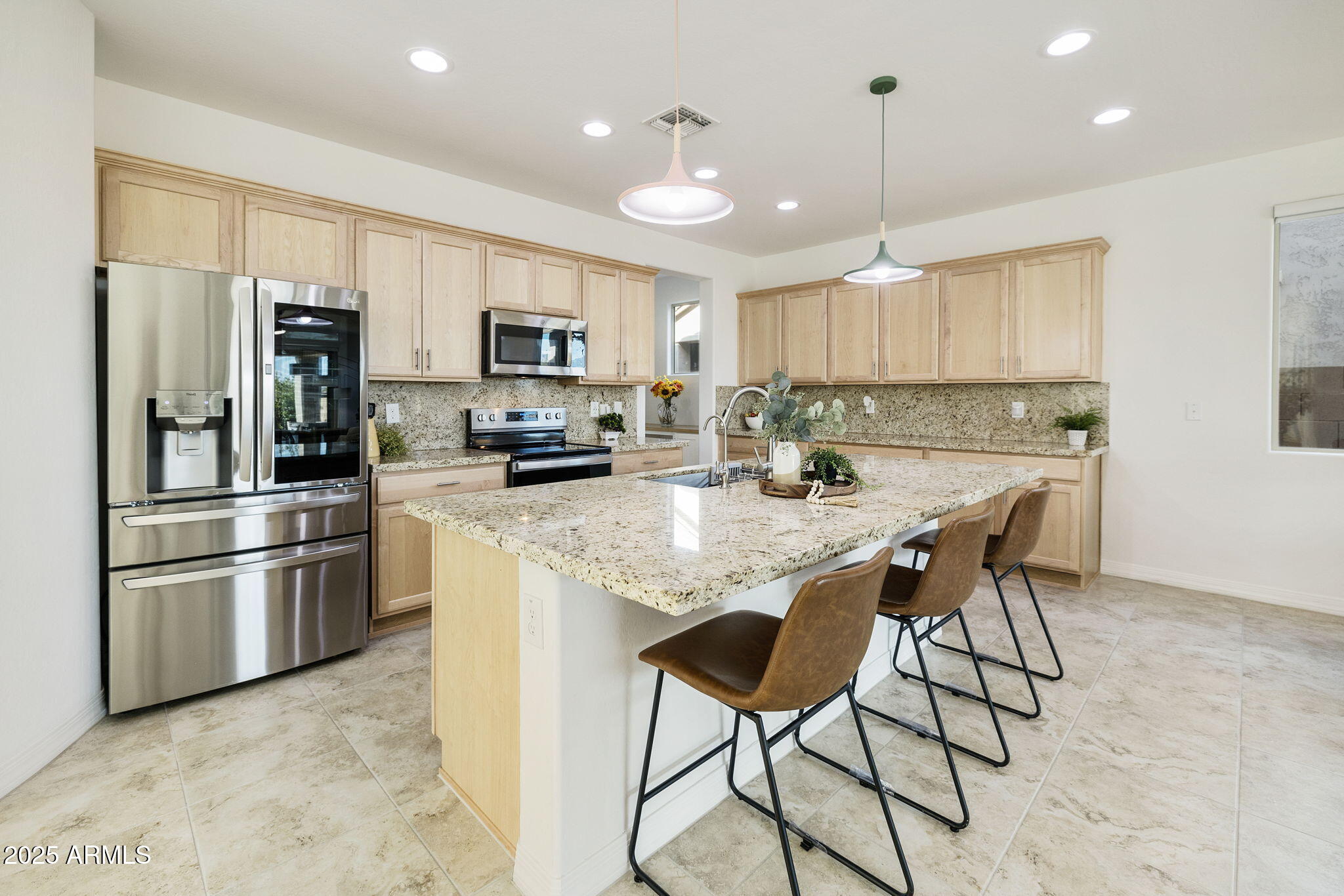 5823 South Del Rancho Mesa, AZ 85212 - Photo 14 of 67 a kitchen with stainless steel appliances kitchen island granite countertop a refrigerator and a stove top oven
