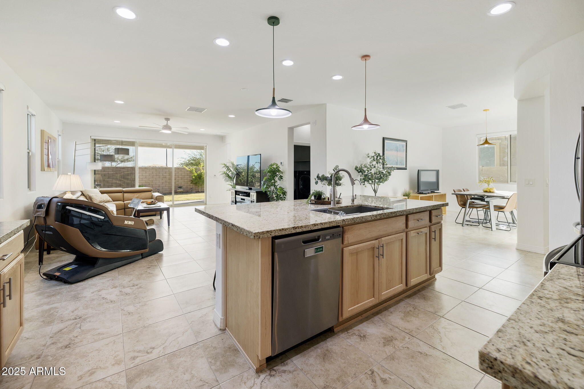 5823 South Del Rancho Mesa, AZ 85212 - Photo 15 of 67 a large kitchen with kitchen island a large counter top a sink a stove and a hard wood floor