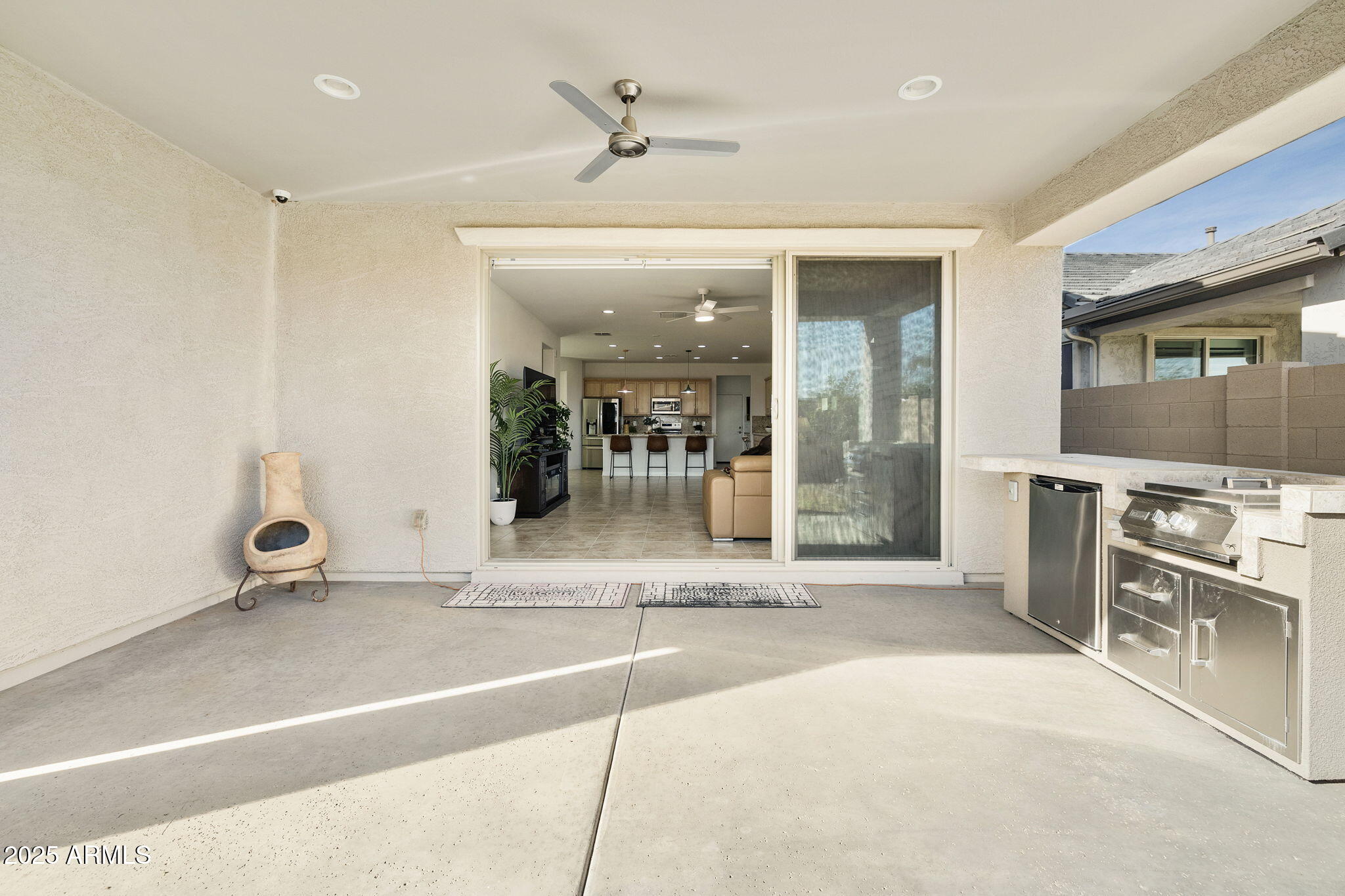 5823 South Del Rancho Mesa, AZ 85212 - Photo 49 of 67 a living room with stainless steel appliances kitchen island granite countertop a table and chairs in it