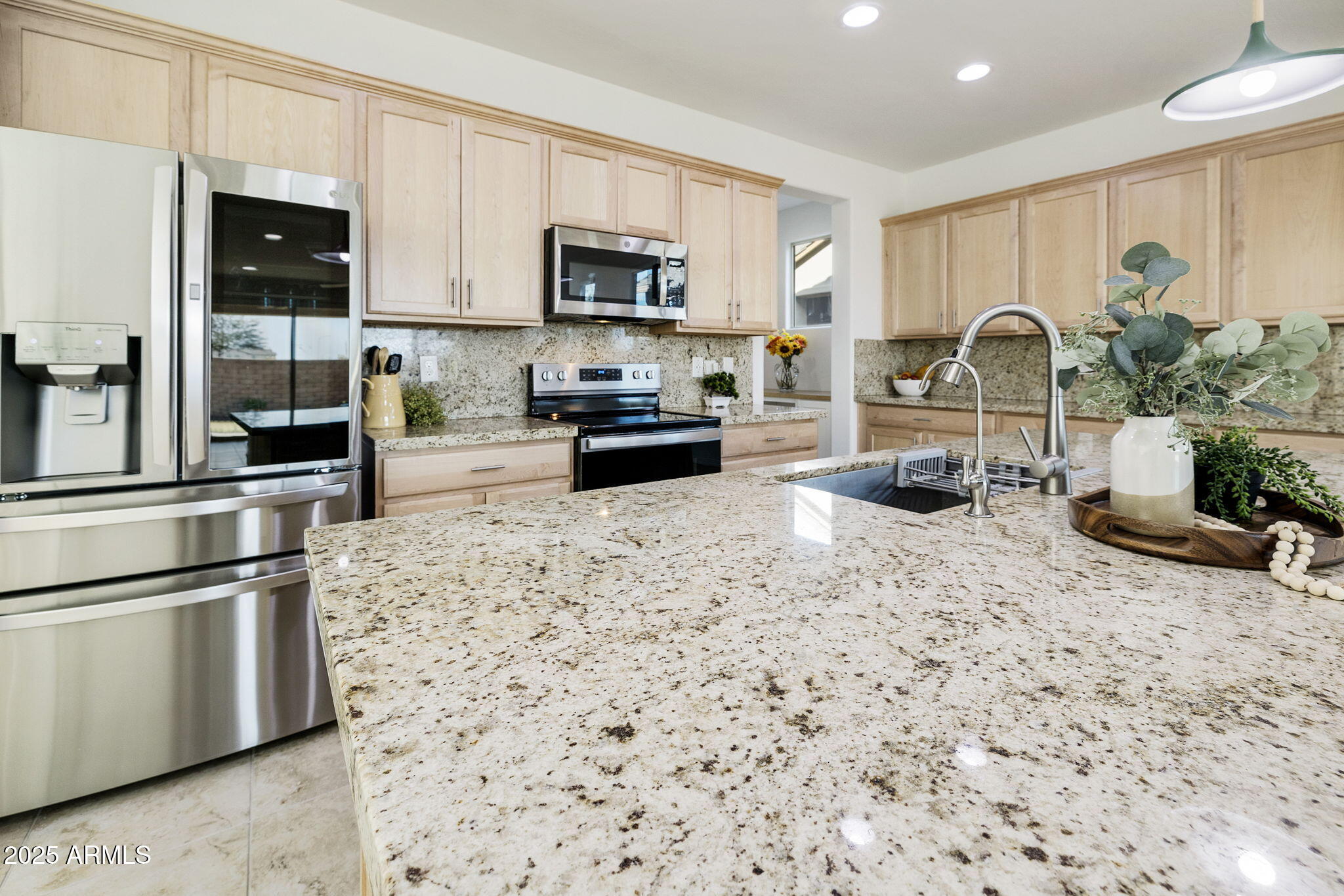 5823 South Del Rancho Mesa, AZ 85212 - Photo 5 of 67 a kitchen with stainless steel appliances granite countertop a refrigerator a stove a sink and a microwave