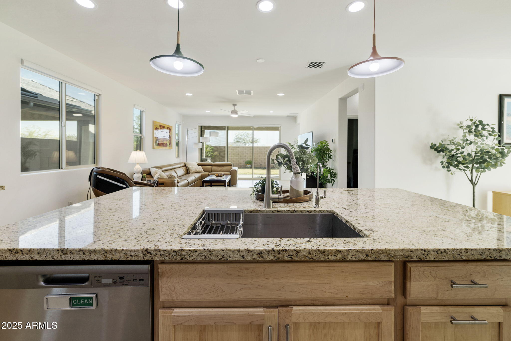 5823 South Del Rancho Mesa, AZ 85212 - Photo 7 of 67 a kitchen with granite countertop a sink a counter top space and living room view