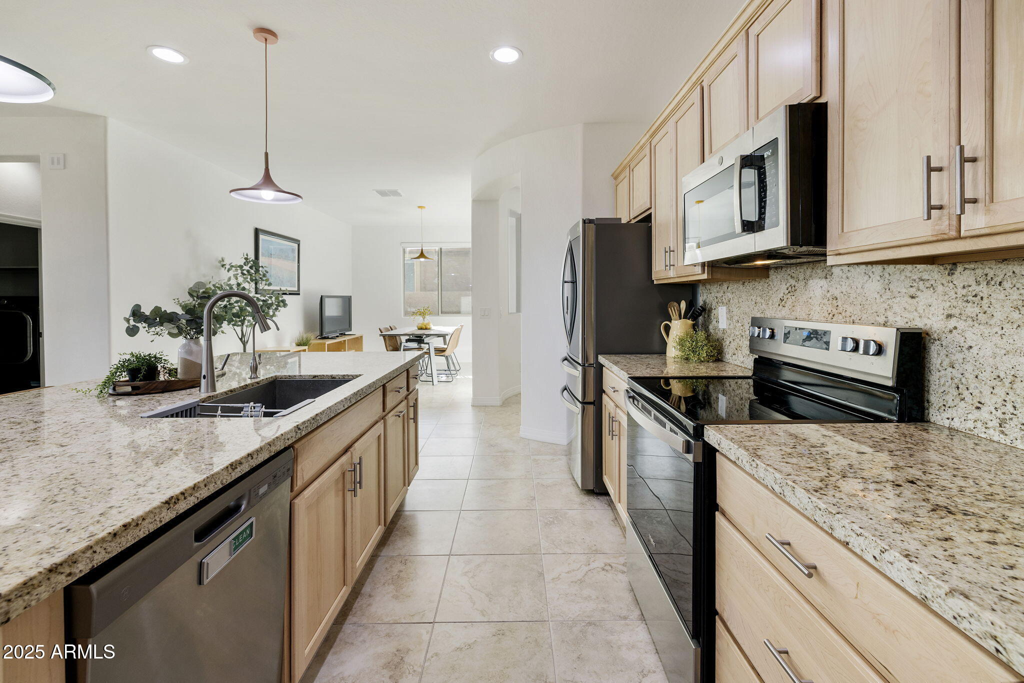 5823 South Del Rancho Mesa, AZ 85212 - Photo 8 of 67 a kitchen with stainless steel appliances granite countertop a sink a stove and a wooden cabinets
