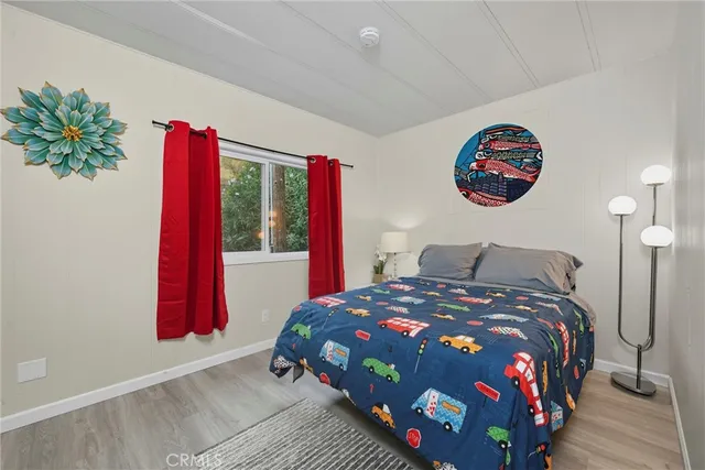 a bedroom with a bed and a potted plant