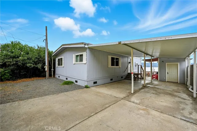 a backyard of a house with table and chairs