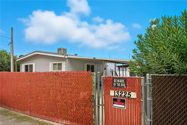 a view of a house with wooden fence