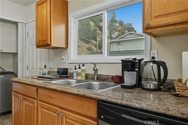 a kitchen with granite countertop a sink and a window