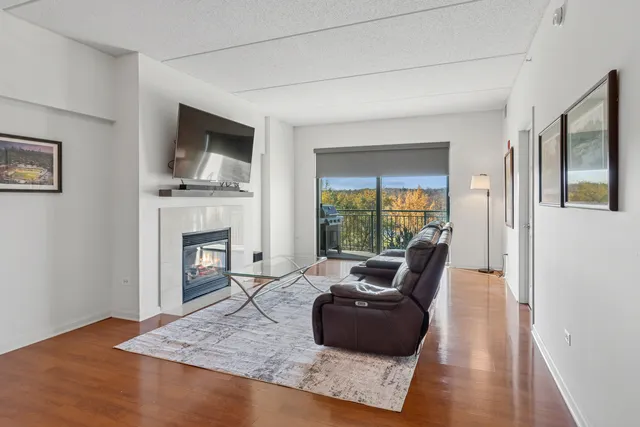 a living room with furniture fireplace and flat screen tv