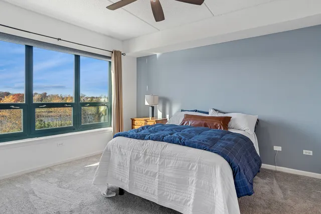 a bedroom with a large bed and a large window