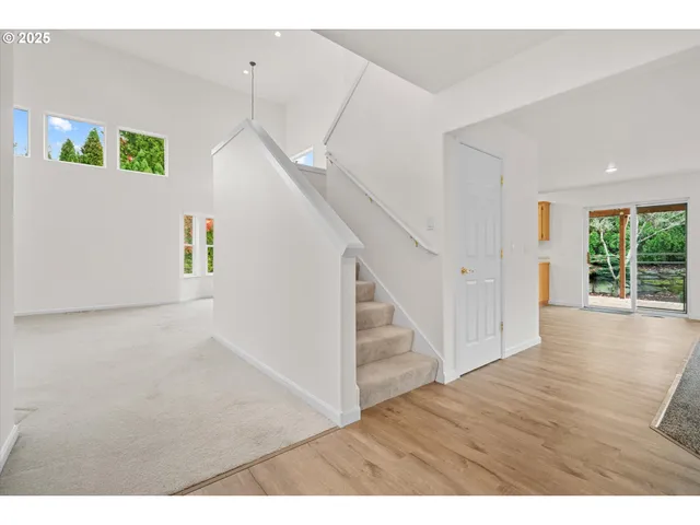 a view interior of a house with wooden floor stairs and windows