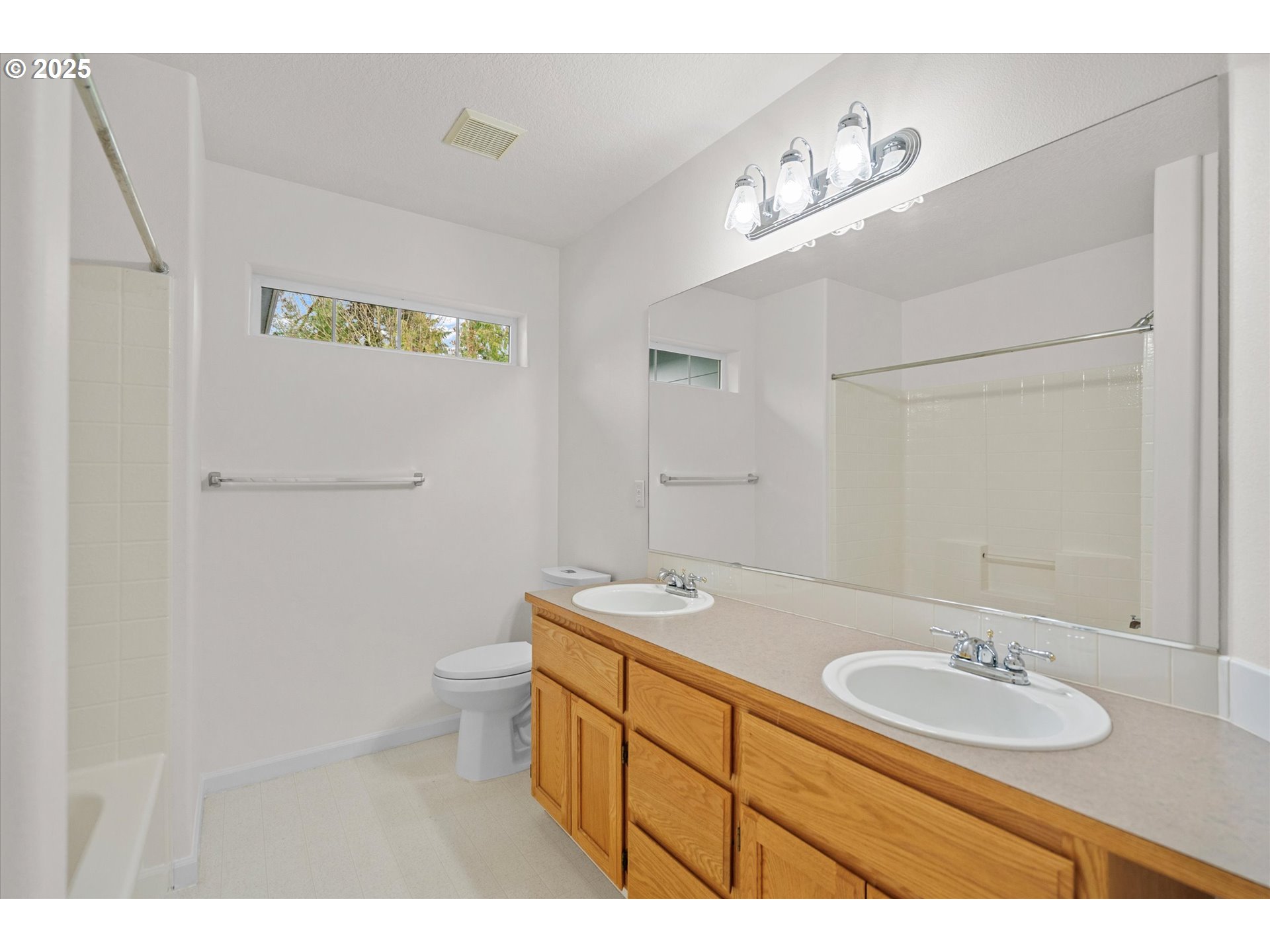 12262 Southwest 114th Terrace Portland, OR 97223 - Photo 30 of 41 a bathroom with a sink a toilet and mirror