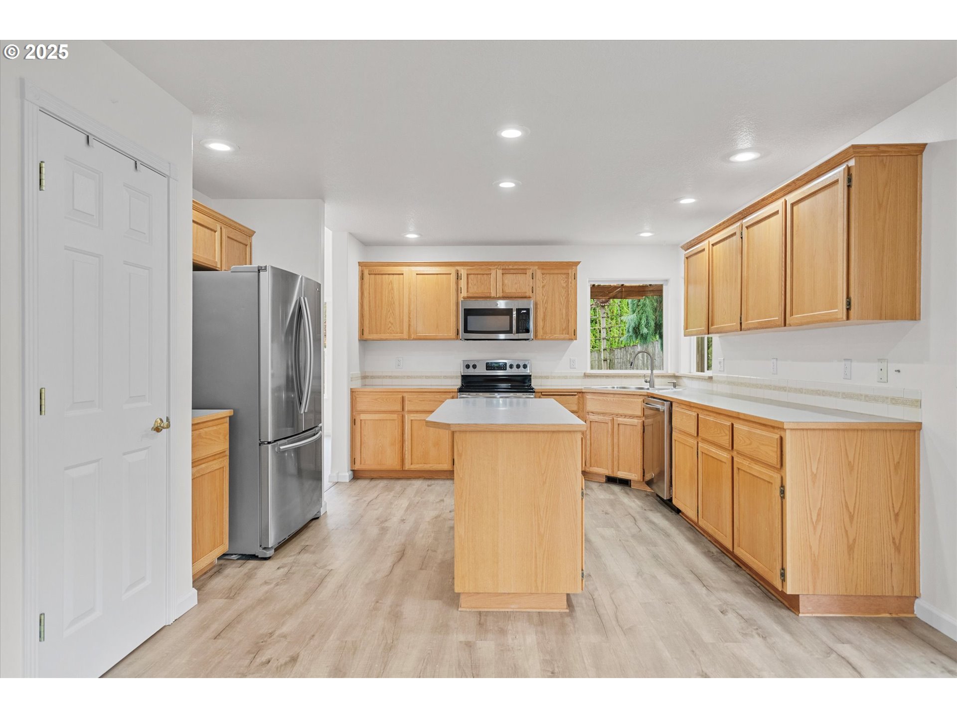 12262 Southwest 114th Terrace Portland, OR 97223 - Photo 3 of 41 a kitchen with stainless steel appliances granite countertop a refrigerator stove top oven and sink