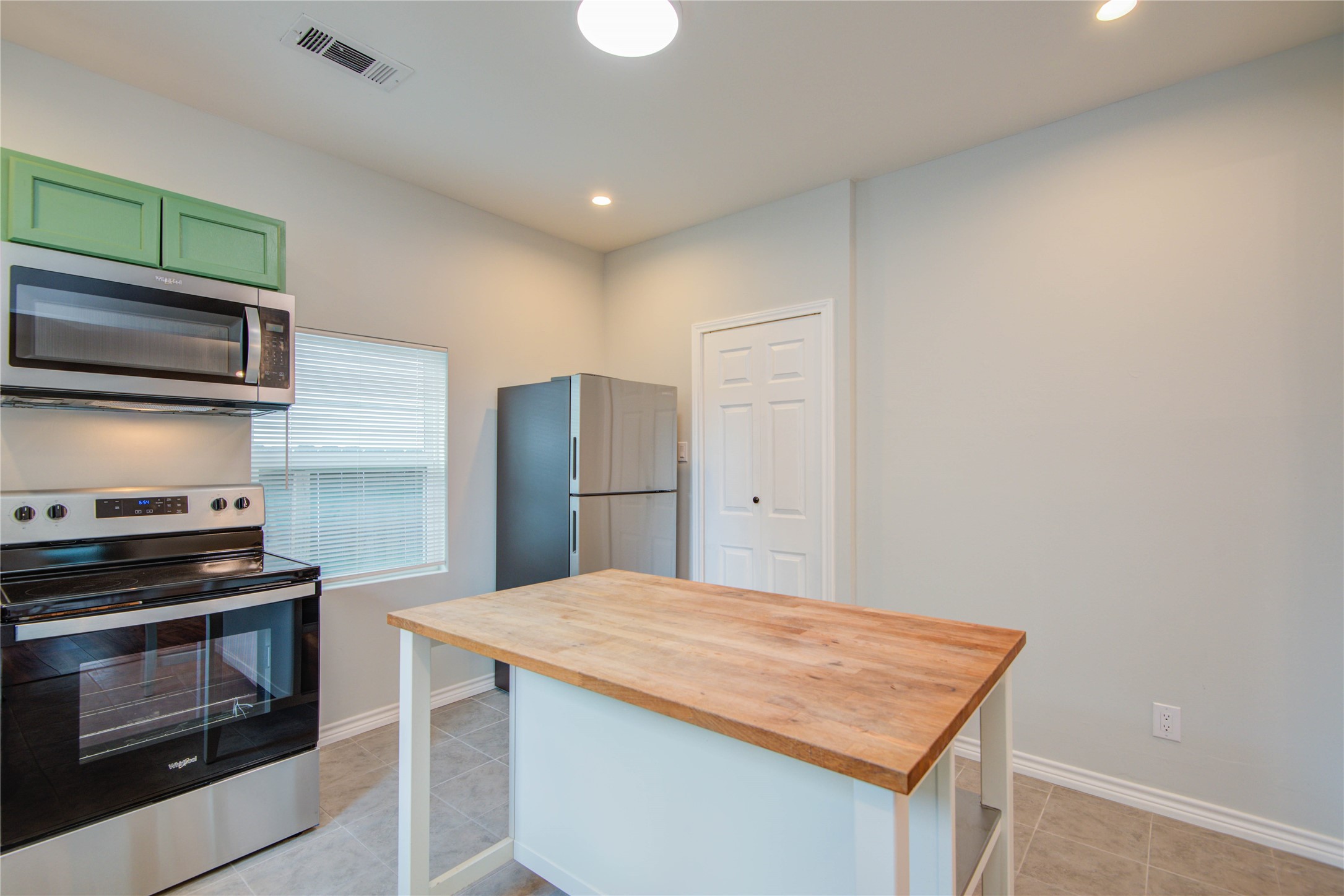 2712 Link Road Houston, TX 77009 - Photo 13 of 35 a kitchen with stainless steel appliances kitchen island a stove and a microwave