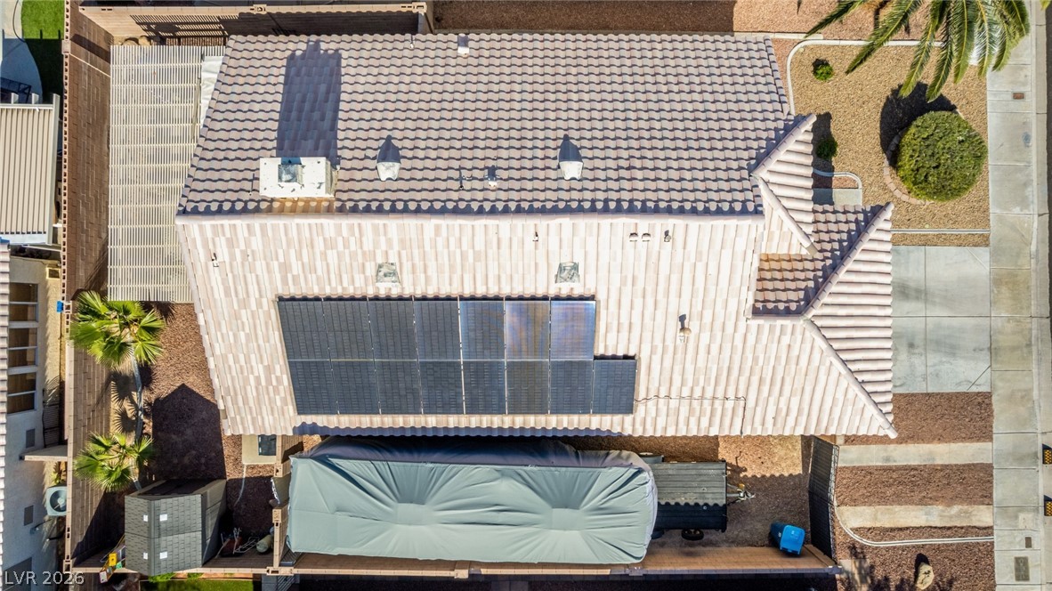 5112 West Camino Del Rancho Las Vegas, NV 89130 - Photo 42 of 44 This aerial view showcases a residential property featuring a well-maintained roof and solar panels.