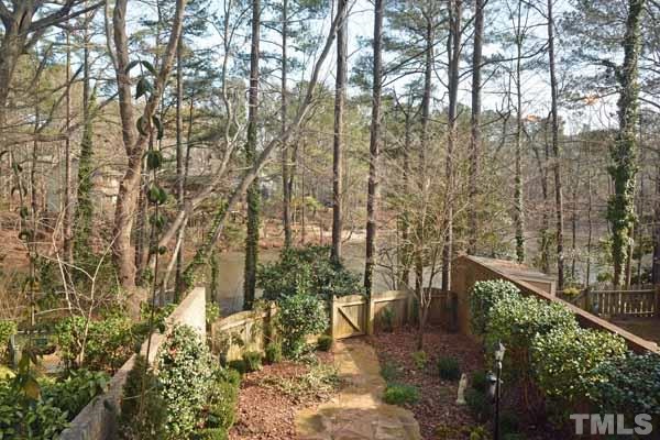 3002 Wycliff Road Raleigh, NC 27607 - Photo 11 of 21 a backyard of a house with lots of green space and a fountain