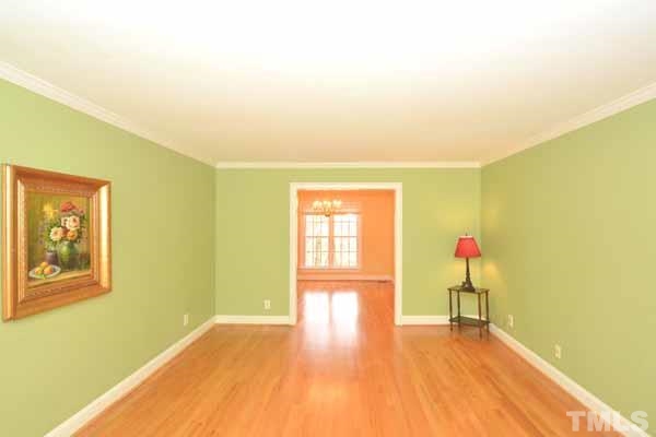 3002 Wycliff Road Raleigh, NC 27607 - Photo 6 of 21 a view of an empty room with wooden floor and a window