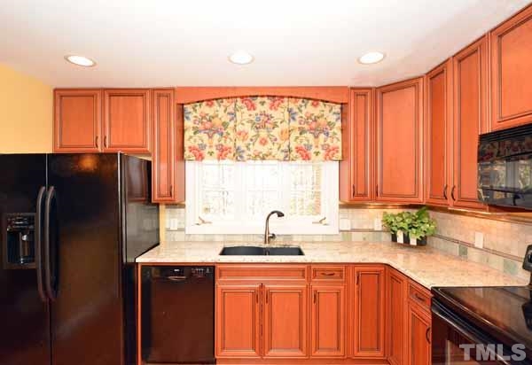 3002 Wycliff Road Raleigh, NC 27607 - Photo 8 of 21 a kitchen with stainless steel appliances granite countertop a refrigerator a sink dishwasher and wooden cabinets with a large window