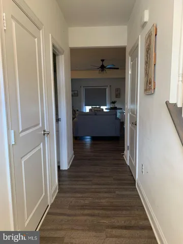 a view of a hallway view with wooden floor and staircase